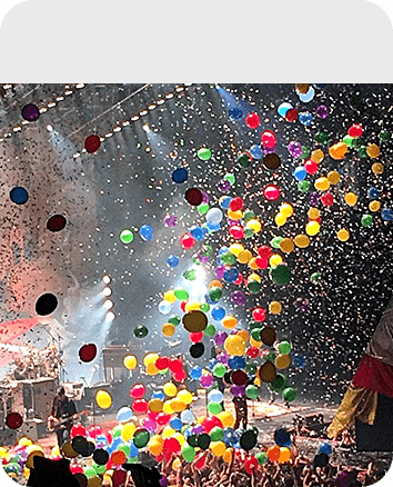 Exploding balloon and confetti on a concert event