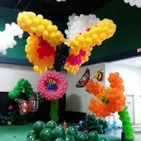 butterfly and flowers balloon decorations on an indoor event